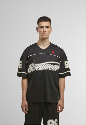 Black jersey with white accents and "Rocawear" logo. Short sleeves, V-neck, and large number 99 on both sides. Made of breathable fabric.
