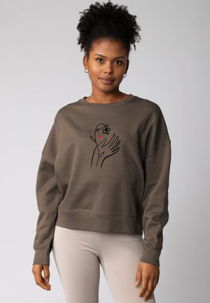 Sweatshirt en coton marron à coupe décontractée, avec un motif de main contourné, une fleur et un cœur au centre. Poignets et ourlet côtelés.