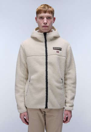 Beige fleece jacket with hood, zip front, side pockets, and black accents. Features a logo patch on the upper left chest area.