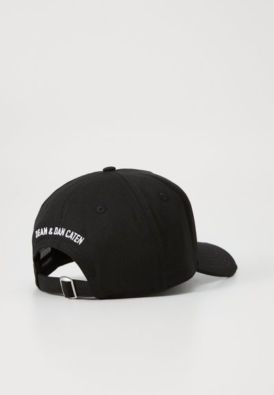 Black cotton baseball cap with a rounded crown, curved brim, and embroidered label on the back. Adjustable strap with a metal buckle.
