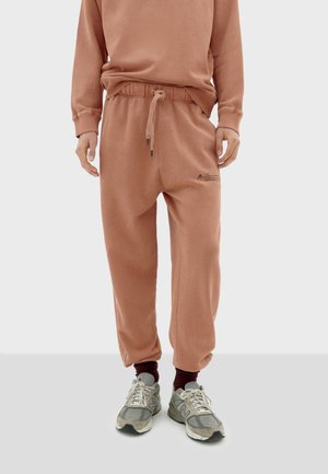 FLOWERS UNISEX - Tracksuit bottoms - salmon pink