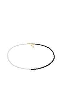 Perlekæde med et sort og hvidt design, best�ående af små runde perler, med en guldspænde og justerbar kæde.