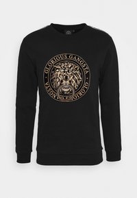 Felpa nera in cotone, con una grafica circolare dorata di un leone e la scritta "GLORIOUS GANGSTA". Polsini e orlo a costine.