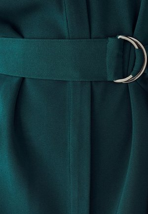 Teal fabric with a smooth texture, featuring a belt with a silver circular buckle and pleated detail below the waist.