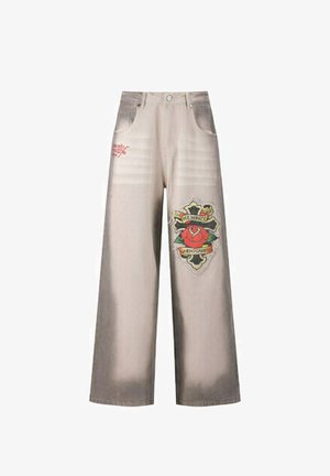 Denim wide-leg pants in light beige with faded areas. Features front pockets and a colorful graphic patch with a rose and text.