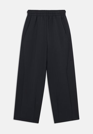 Pantalones sueltos negros con cinturilla elástica y bolsillos laterales, hechos de tela suave, mostrados extendidos sobre un fondo blanco.
