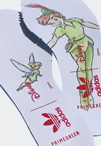 White insoles featuring designs of Peter Pan and Tinker Bell, with red Adidas logo and "PRIMEGREEN" text. Smooth fabric texture.