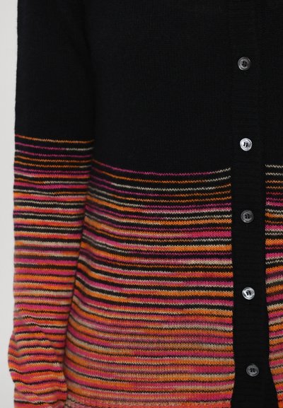 Black cardigan with multicolored horizontal stripes in pink, orange, and gray. Features silver buttons along the front. Soft knit texture.
