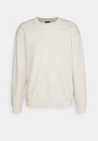 Sweatshirt beige clair avec design embossé, col rond, manches longues, poignets et ourlet côtelés. Texture douce, coupe décontractée.