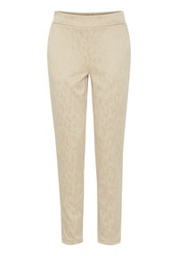 Beżowe dresy z delikatnym nadrukiem w panterkę, elastycznym pasem, dopasowanym krojem oraz miękką teksturą materiału. Bez kieszeni ani elementów metalowych.