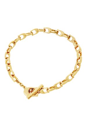 Bracelet chaîne en or avec des maillons ovales allongés et un fermoir à bascule, disposé en forme circulaire sur un fond blanc.