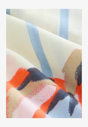 Patterned fabric featuring soft, textured cotton with abstract shapes in coral, beige, navy, and light blue against a cream background.