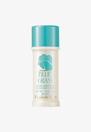 Container de déodorant crème avec un capuchon à vis teal. La base ivoire présente du texte bleu et doré, ainsi qu'un graphique bleu de la tête d'un lion.