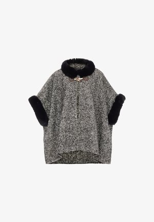 Fekete-fehér houndstooth mintás köpeny, műszőrme gallérral és mandzsettákkal, két barna gombbal záródik.