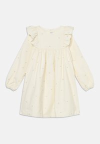 Rochie crem cu mâneci lungi, cu umeri volănați, având broderie cu stele mici pe întreaga suprafață. Material din bumbac cu talie plisată pentru un aspect plin.