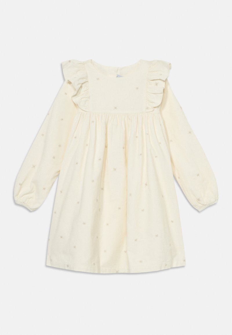 Rochie crem cu mâneci lungi, cu umeri volănați, având broderie cu stele mici pe întreaga suprafață. Material din bumbac cu talie plisată pentru un aspect plin.