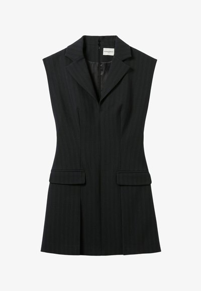 Blazer sin mangas negro a rayas con collar de muesca, dos bolsillos frontales y cierre con cremallera oculto en la parte posterior. Diseño entallado.