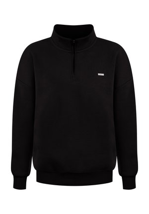Pullover nero a maniche lunghe con zip a quarti e piccolo patch fluorescente bianco sul lato sinistro del petto, polsini e orlo a coste.