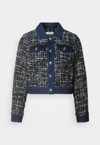 Veste courte en tweed noir, blanc et bleu avec col, poignets, ourlet, patte de boutonnage et poches poitrine en denim bleu foncé avec boutons argentés.