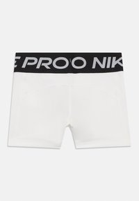 Bijele kratke hlače s crnim elastičnim pojasom na kojem je ispisano "PROOF" i "NIKE" u sivoj boji. Glatka tkanina s bešavnim stranama i prilagođenim dizajnom.