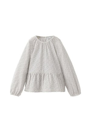 Blouse blanche à manches longues avec petits pois noirs, col rond, coupe ample, poignets élastiques et détail froncé à la taille.