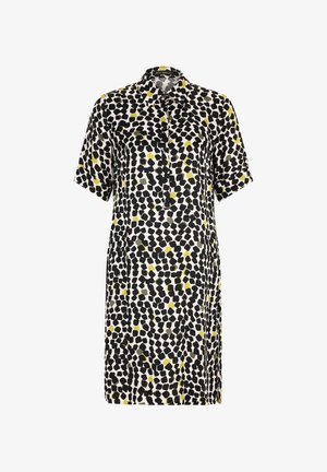 Lyhythihainen paitamekko, jossa on kauluspaita, musta, vihreä ja keltainen abstrakti kuvio kermaista taustaa vasten, valmistettu kevyestä kankaasta.