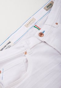 White denim jeans with copper hardware, featuring a blue stitching accent and green-red stripes, labeled "bugatti" and "Berto."
