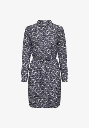 Robe chemise à imprimé géométrique bleu marine et blanc avec manches longues, col, boutons sur le devant et ceinture nouée à la taille.
