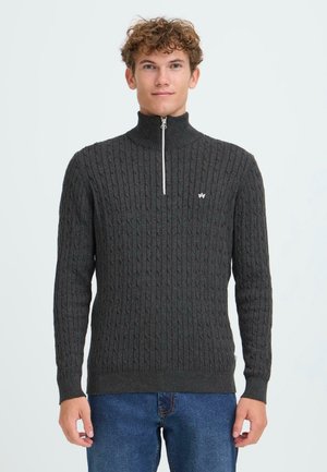 Dark gray knitted sweater with a ribbed texture, high collar, and half zipper. Features a small logo on the chest and fitted cuffs.