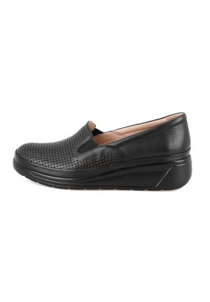 Black slip-on shoe made of perforated leather, featuring a cushioned insole and a molded wedge sole for enhanced comfort and support.