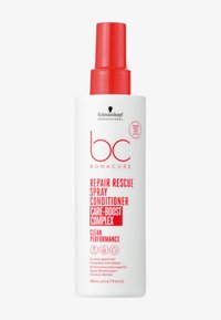 Bouteille pulvérisatrice blanche avec une pompe rouge et un texte rouge audacieux. L'étiquette comprend le nom du produit, les instructions d'utilisation et le volume (200 mL).