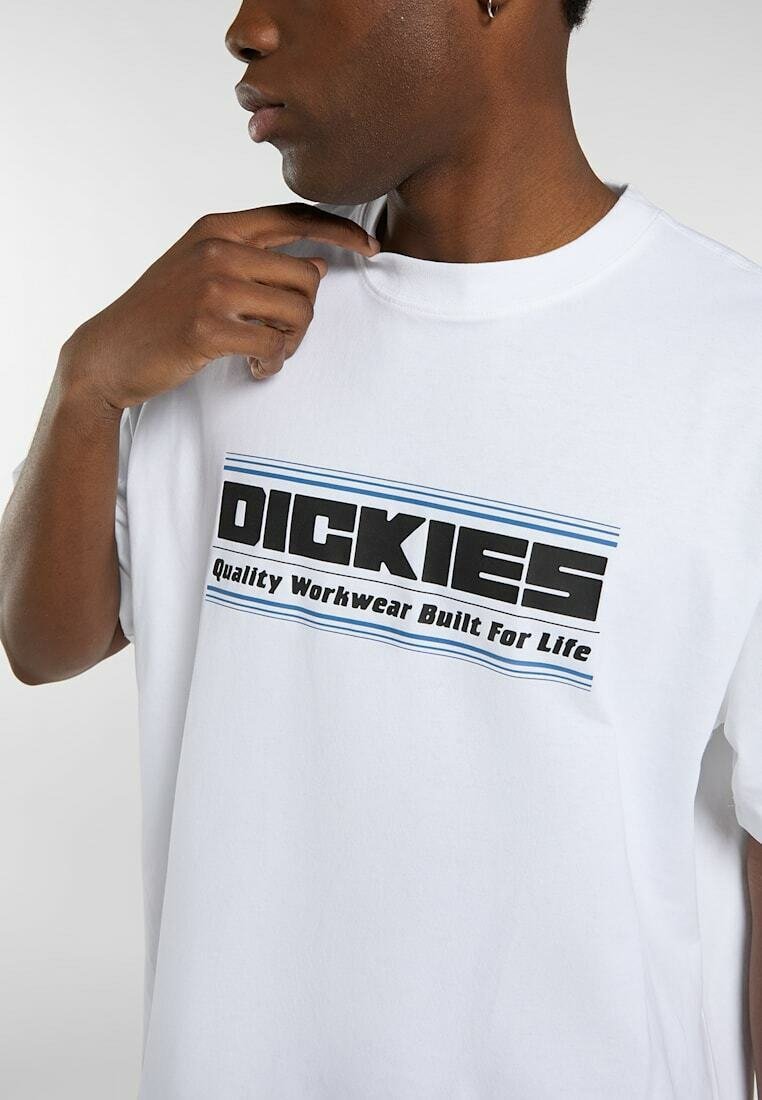 Man wearing white t-shirt with black and blue "Dickies Quality Workwear Built For Life" logo, touching neckline.