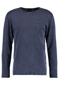 Maglietta a maniche lunghe blu navy in un materiale morbido simile al denim. Design a collo rotondo con cuciture visibili e un piccolo etichetta sull'orlo inferiore.