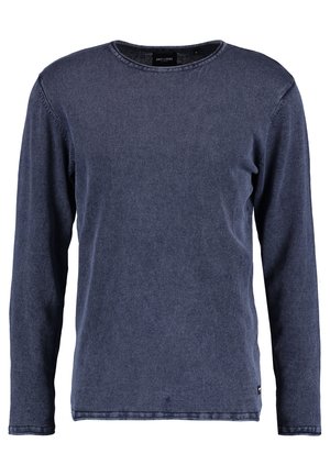 Camisa de manga larga azul marino en un material suave similar al denim. Diseño de cuello redondo con costuras visibles y una pequeña etiqueta en el dobladillo inferior.