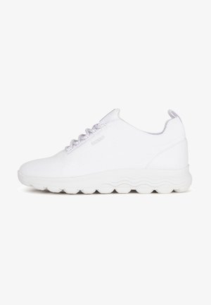 White sneaker with a textured knit upper, lace-up closure, and a cushioned, wave-patterned sole. Features a pull tab at the heel.
