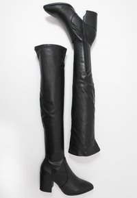 Black over-the-knee boots made of smooth faux leather, featuring a pointed toe and block heels, with a side zipper for closure.