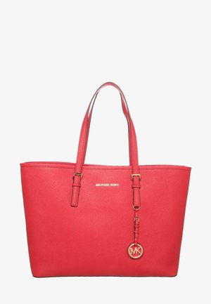 Rode Michael Kors handtas met dubbele riemen en een gouden MK-logohanger die aan één riem hangt.