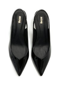 Zapatos de tacón slingback de charol negro con punteras afiladas y lados recortados. Textura suave, tacones delgados y sutil logo dorado en las plantillas.