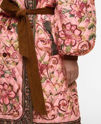 Quilted pink coat featuring floral patterns, a brown corduroy belt, and button accents. The design includes contrasting green and brown trims.