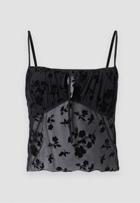 Top camicia nera con spalline sottili, caratterizzato da un motivo floreale. Realizzato in tessuto trasparente con texture floreali più scure, arricciato sul busto con un dettaglio a fiocco.