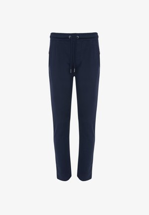 Marineblauwe joggingbroek met een trekkoord in de taille, zijzakken en taps toelopende pijpen, gemaakt van een zachte stof met een gladde textuur.