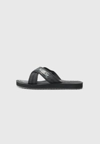 Black flip-flop sandal with textured fabric straps, smooth rubber sole, and embossed logo detail on the insole. Designed for casual wear.