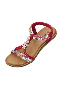 Röd sandal med flätade blomsterremmar, prydnadsblommor och små metalliska accenter. Mjuk fotbädd med en platt, texturerad sula.