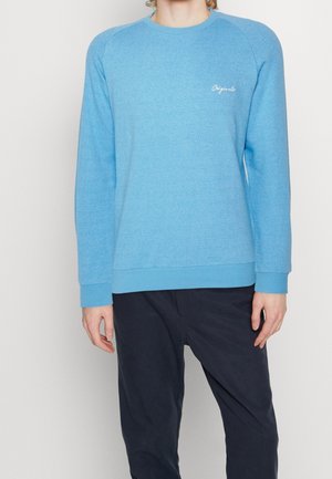 Lyseblå crewneck sweatshirt med et struktureret mønster, ribbede manchetter og kant. Forsiden viser et lille hvidt logo på venstre side.