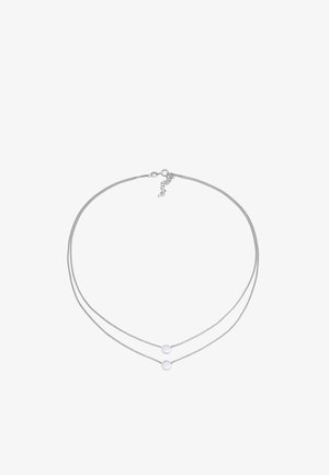 Collier argenté à double couche avec deux disques ronds sur de fines maillons de chaîne, équipé d'un fermoir à homard et d'un mécanisme de longueur ajustable.