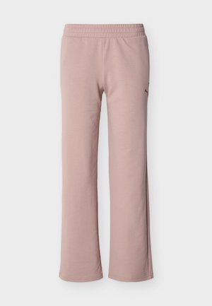 Ružičaste elastične trenirke z ravnimi hlačnicami, z diskretno logotipom na zgornjem delu stegna, prikazane na belem ozadju.