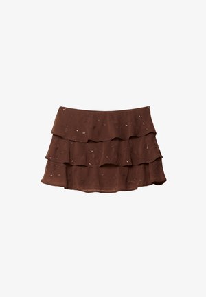 Brauner, gestufter Rock mit drei Rüschen, aus leichtem Stoff mit floralem Muster und metallischen Akzenten. Traditionelles Taillenband-Design.