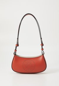 Red leather shoulder bag with a curved shape, featuring perforated logo detail on the front and a contrasting black strap. Smooth texture.