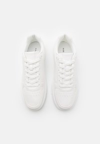 Weiße Sportsneaker aus glattem synthetischem Material, mit runder Zehenpartie, Schnürdesign, durchbrochenen Akzenten und gepolsterter Schuhkragen.