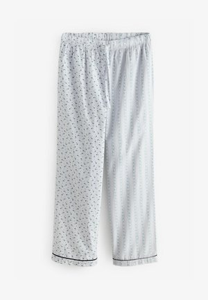 Pantaloni da pigiama in cotone, con un lato caratterizzato da piccoli motivi floreali e l'altro con righe verticali. Entrambi i lati presentano un bordo nero sulle caviglie.